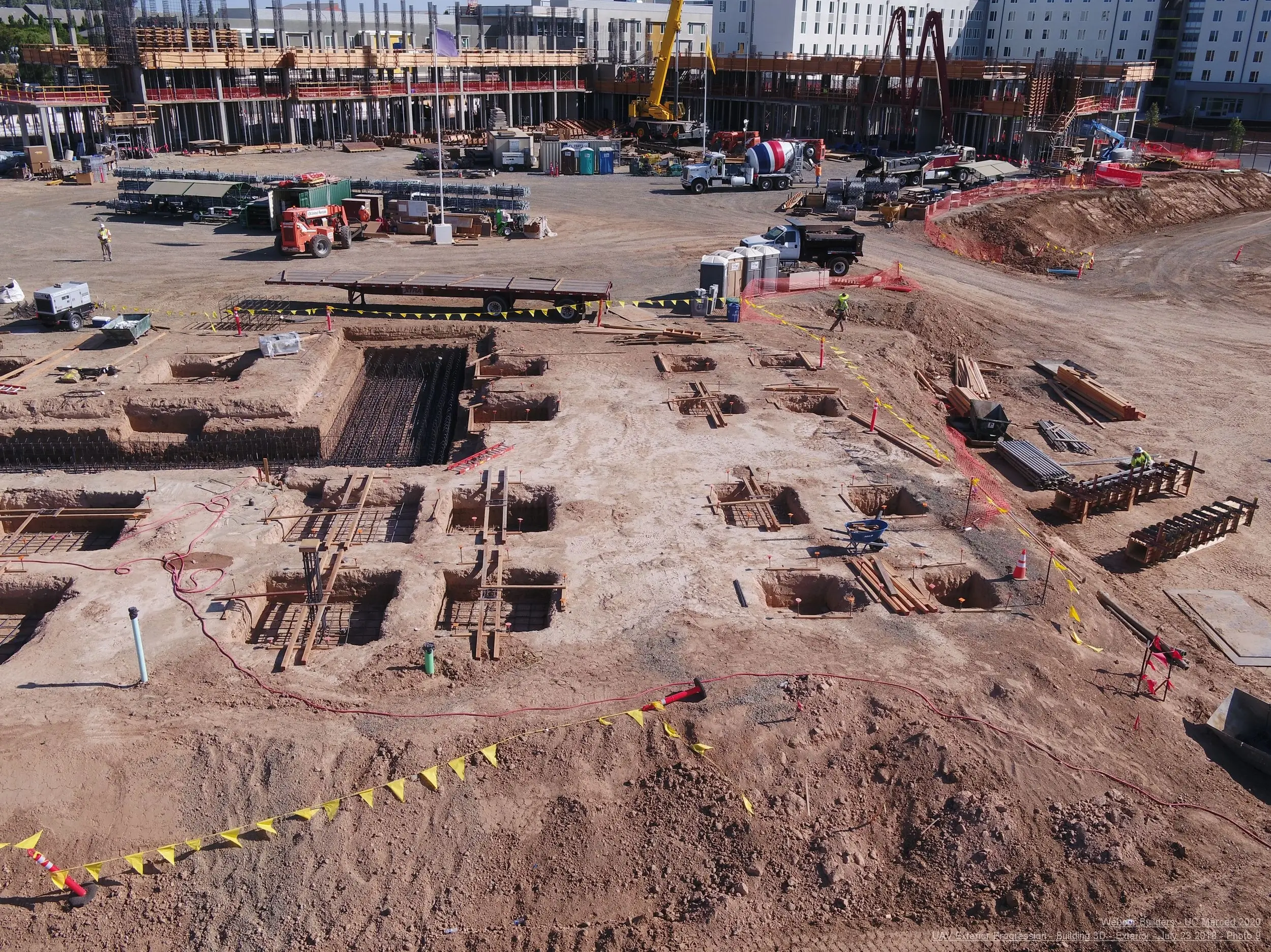 UAV mapping of a large construction site with foundation trenches, rebar, and heavy equipment.