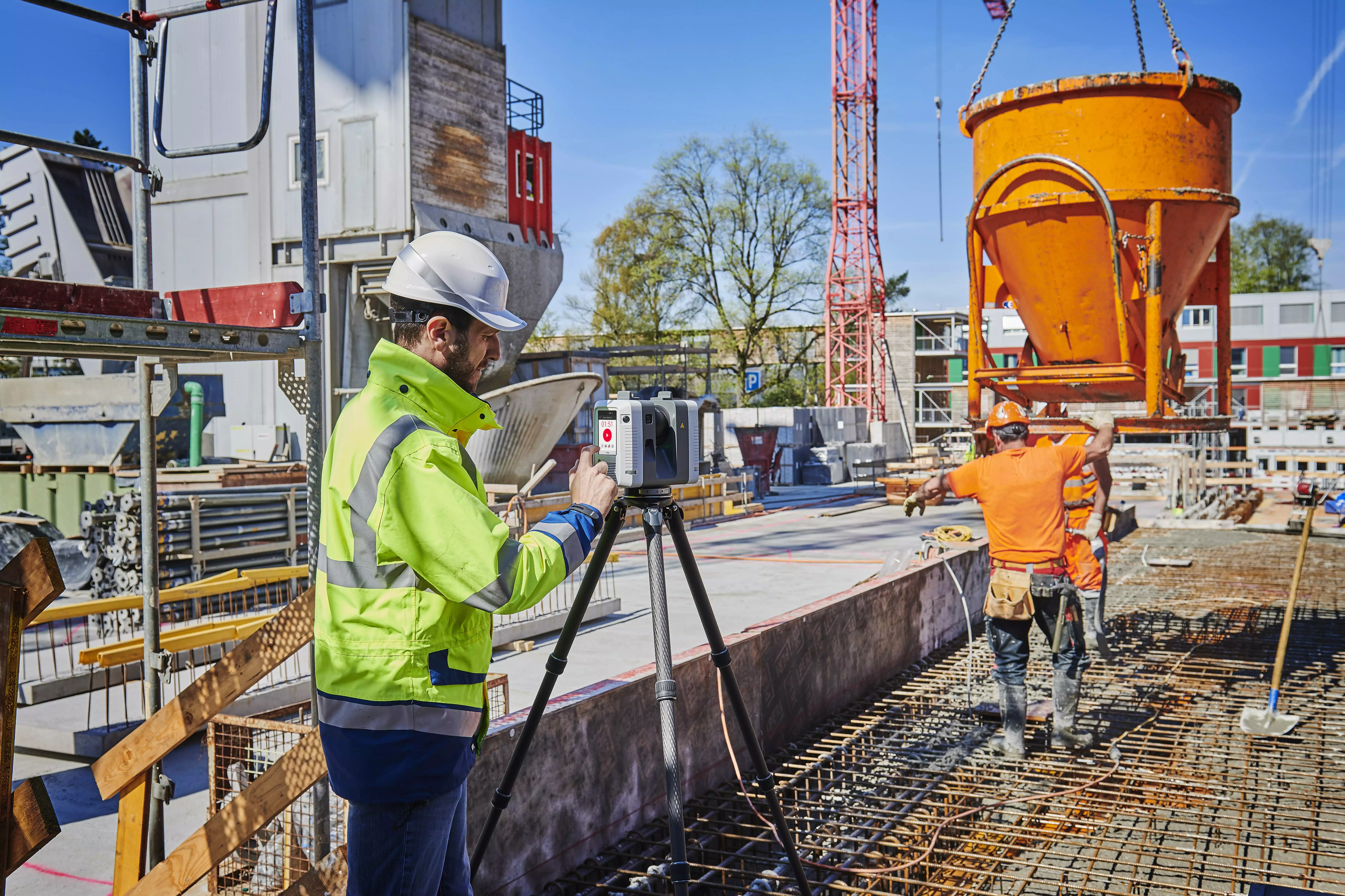 3D laser scanning professionals working on a construction site.