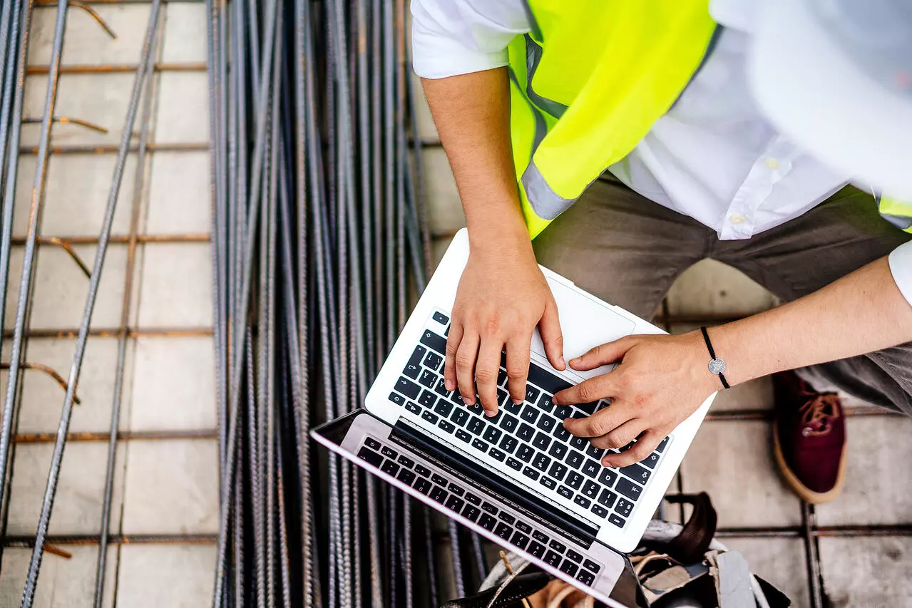 Construction worker using a laptop