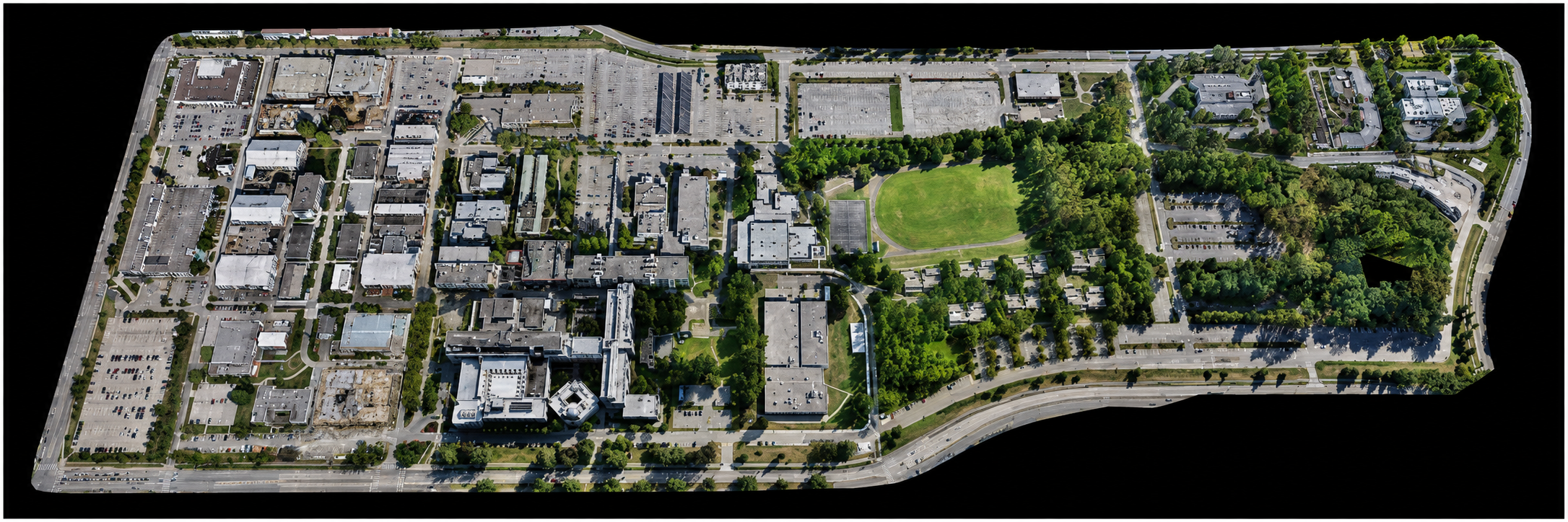 Orthomosaic aerial map of a mixed-use campus with buildings, parking lots, roads, and green spaces.