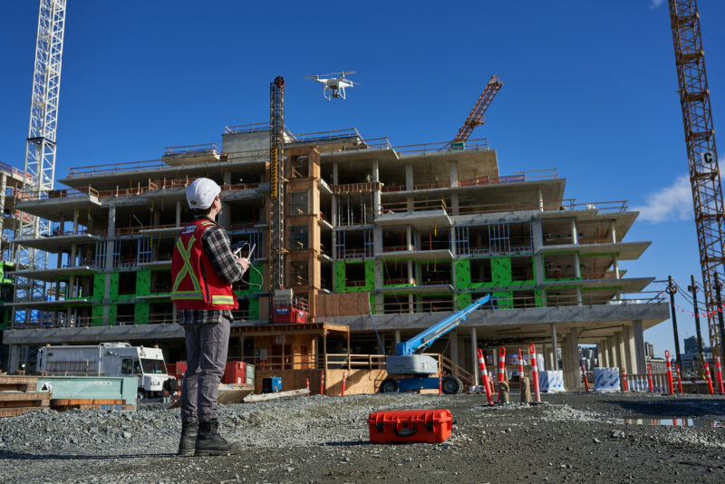 Multivista Documentation Specilist operating a construction drone on a jobsite.