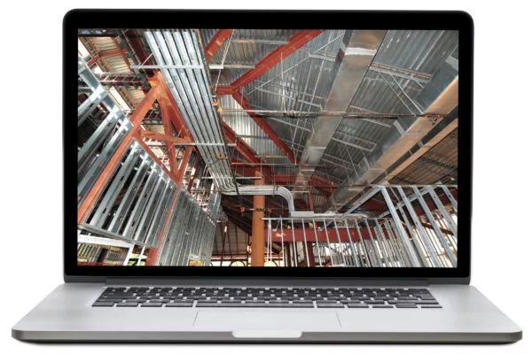Laptop displaying a building under construction, showing red beams, metal ductwork, and wall framing.