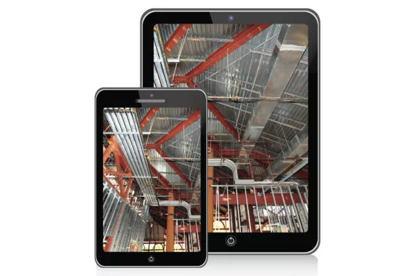 Construction site view with red beams, ductwork, and framing displayed on a smartphone and tablet.