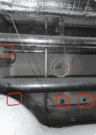 Exposed ceiling utilities including metal pipes, electrical wires, and ductwork, with specific areas highlighted by red boxes.