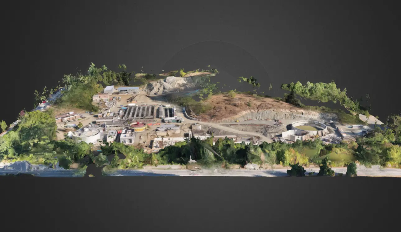 3D model of a complex industrial site featuring buildings, ongoing construction, and natural landscapes.
