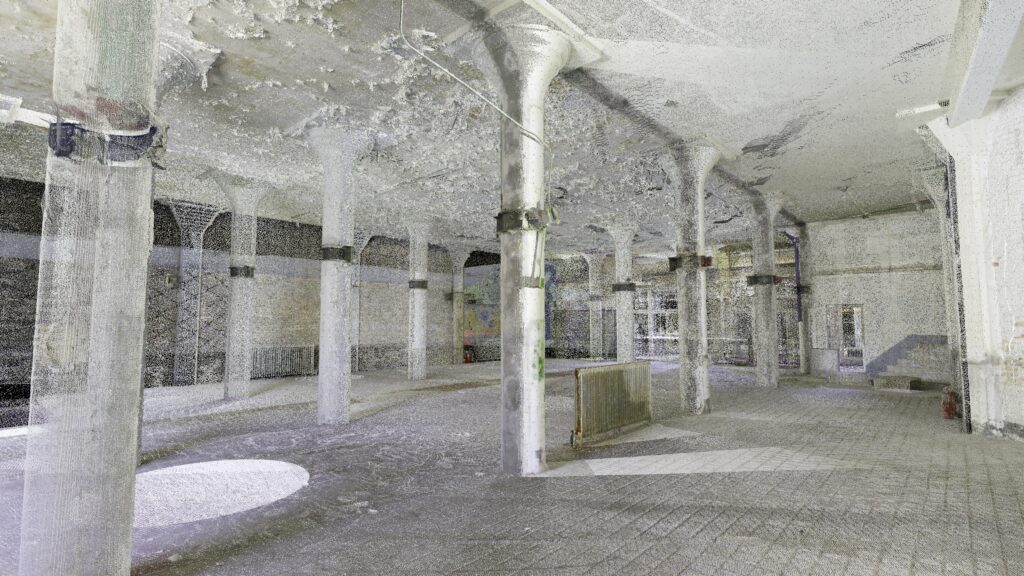 Point cloud capture of a large, empty industrial interior with rows of columns and textured surfaces.