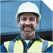 Happy male construction worker in a white hard hat and yellow safety vest.