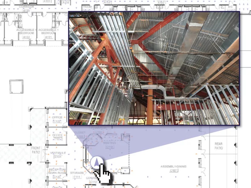 Mouse click on a construction blueprint reveals an overlay of active building construction with exposed framework.