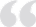 Light gray double quotation mark symbol.