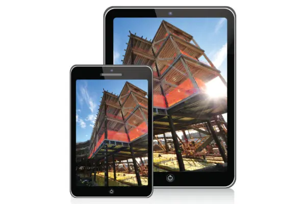 Mobile phone and tablet showing a modern geometric structure with orange elements under a bright blue sky.