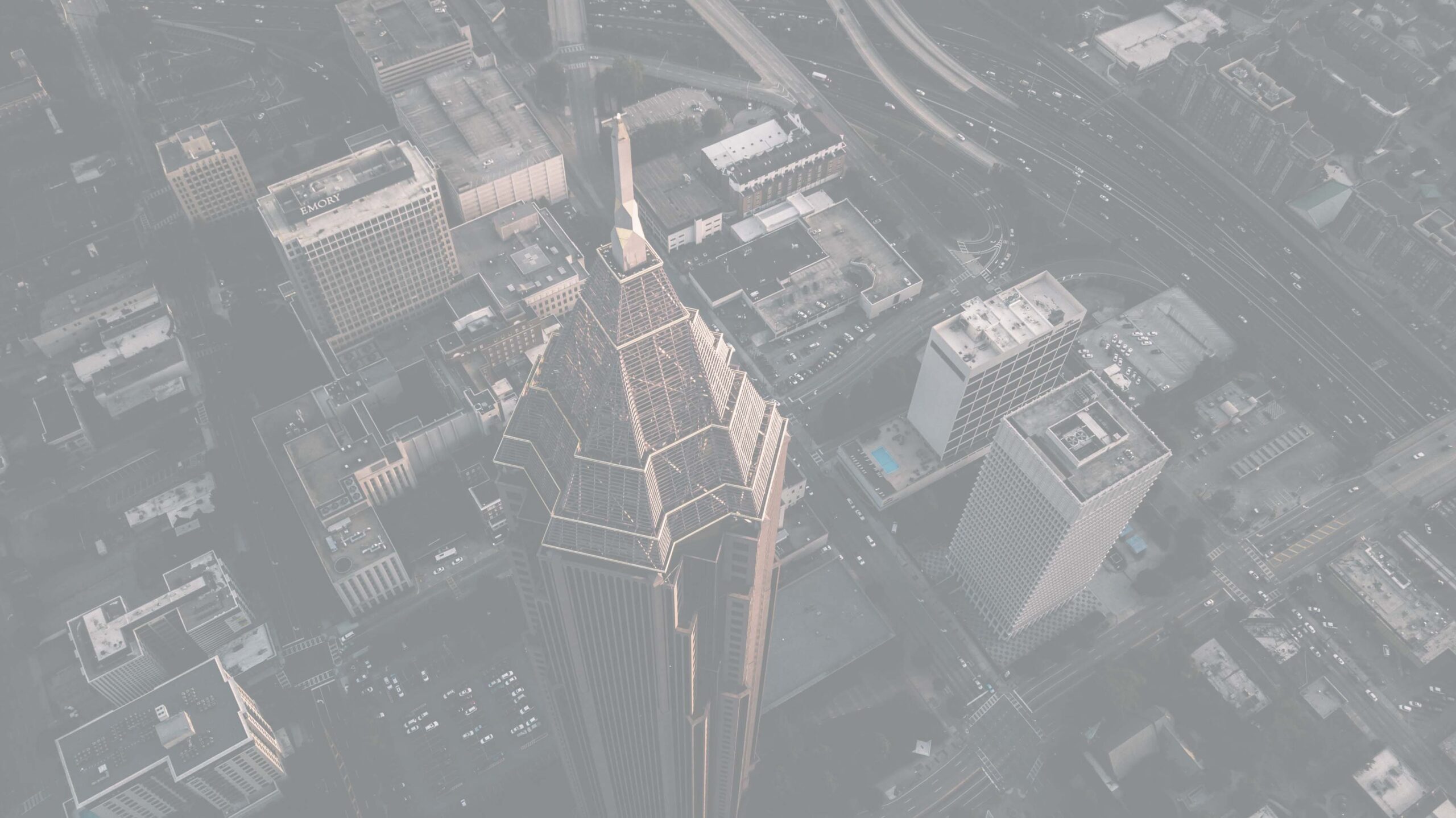 Aerial view of Atlanta city with the prominent Bank of America Plaza skyscraper, highways, and other buildings.