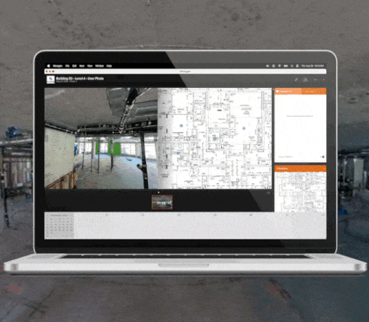 Laptop screen displays construction site photo, floor plan with markers, and project management interface.