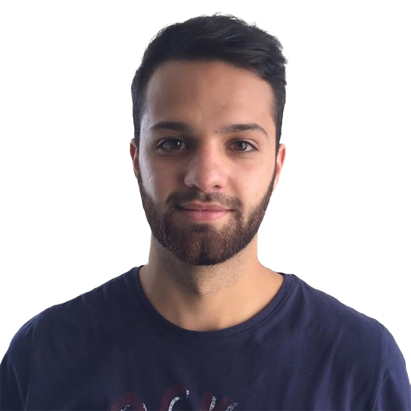 Young man with dark hair and beard wearing a navy t-shirt, smiling at the camera.