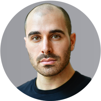 Professional headshot of a man with short dark hair and a black shirt, looking forward.